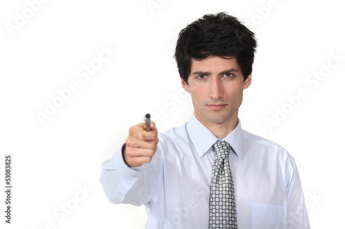 Photo: man in a suit holding a pen man in a suit holding a pen