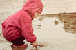 little girl playing in the puddle