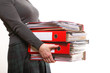 Photo: Female office worker carrying a stack of files Female office worker carrying a stack of files