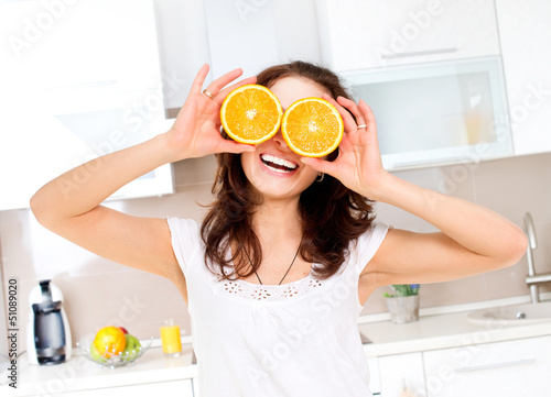 Photo: Portrait of Young and Healthy Funny Woman with Orange over Eyes Portrait of Young and Healthy Funny Woman with Orange over Eyes