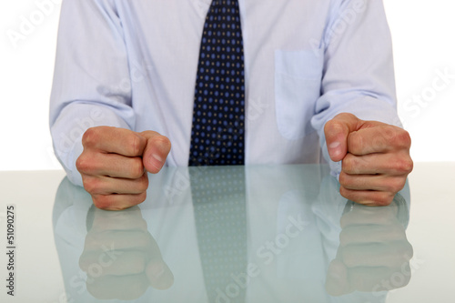 Photo: Male with fists on the table Male with fists on the table