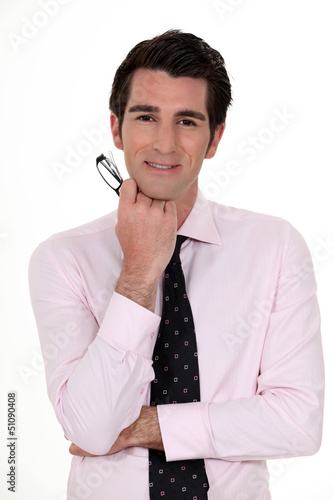 Photo: Businessman holding glasses Businessman holding glasses
