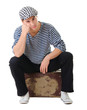 Sad waiting young male traveler on vintage suitcase