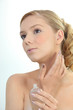 Woman putting on perfume