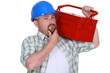 craftsman holding a tool box and touching his chin