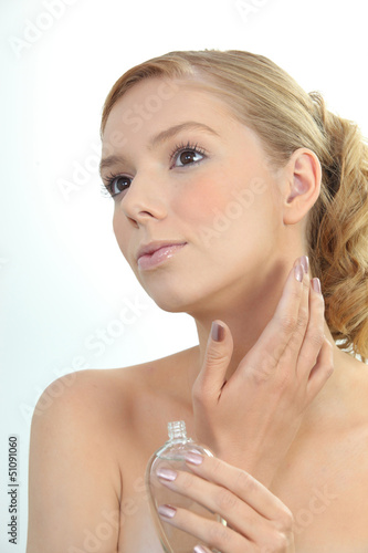 Photo: Woman putting on perfume Woman putting on perfume