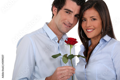 Photo: Man giving rose to woman Man giving rose to woman