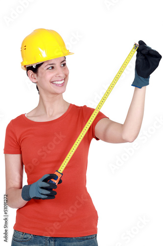 Photo: Woman using tape measure Woman using tape measure