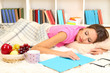 Young female asleep while reading book on floor