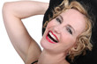 Close up of laughing woman in red lipstick and a black hat