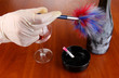 Taking fingerprints with bottle of wine on wooden table