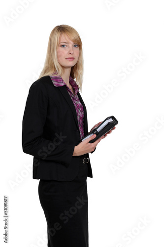 Photo: Blond businesswoman holding diary Blond businesswoman holding diary