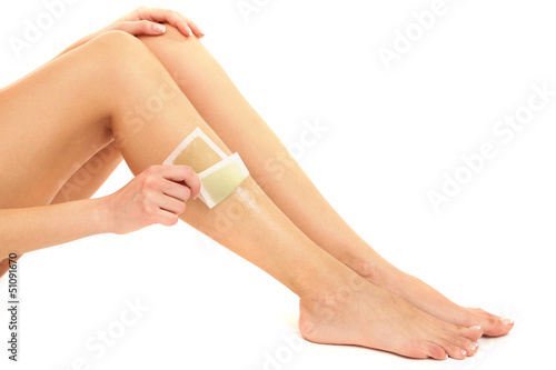 Photo: Beautiful woman doing depilation for her legs with waxing, Beautiful woman doing depilation for her legs with waxing,