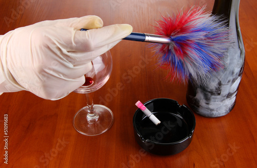 Photo: Taking fingerprints with bottle of wine on wooden table Taking fingerprints with bottle of wine on wooden table