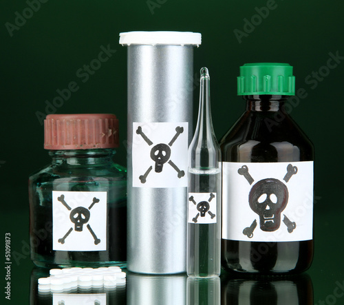 Photo: Deadly poison in bottles on black background Deadly poison in bottles on black background