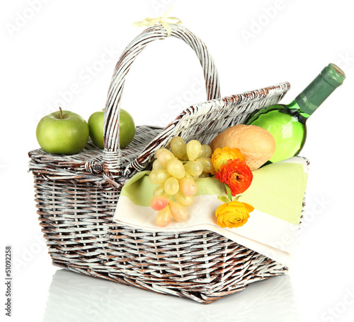 Photo: Picnic basket with fruits and bottle of wine, isolated on white Picnic basket with fruits and bottle of wine, isolated on white