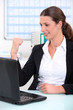 businesswoman delighted with what she can see on her computer