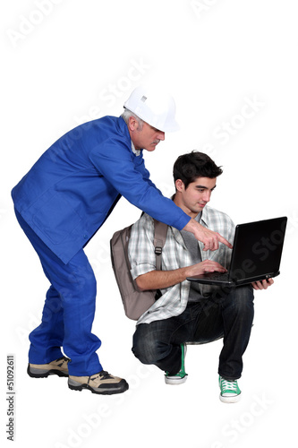 Photo: Grey-haired builder with young apprentice Grey-haired builder with young apprentice