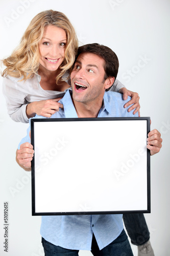 Photo: Couple with white board Couple with white board