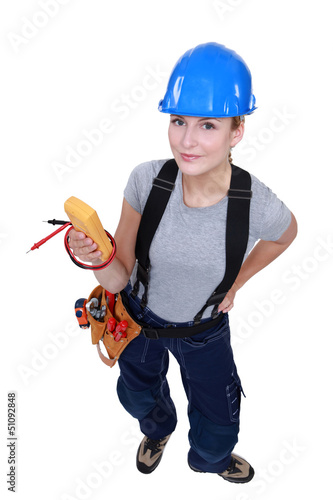 Photo: A female electrician with a voltmeter. A female electrician with a voltmeter.