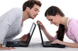 Photo: Man stealing a glance at his neighbour's laptop Man stealing a glance at his neighbour's laptop
