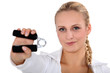 blonde woman using hand grip