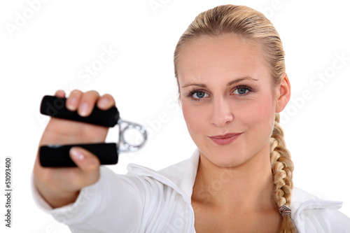 Photo: blonde woman using hand grip blonde woman using hand grip