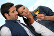 Couple looking at a glass of alcohol