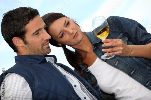 Photo: Couple looking at a glass of alcohol Couple looking at a glass of alcohol