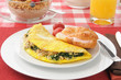 Breakfast omelet and a croissant with cream cheese