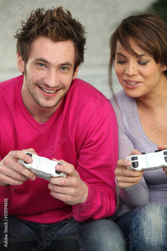 Photo: Young playing with console Young playing with console