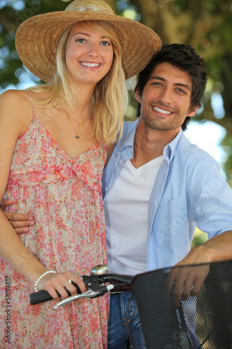 Photo: Couple with bike by springtime Couple with bike by springtime