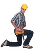Builder kneeling