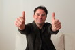 Attractive man with both thumbs up