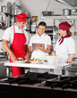 Chefs Using Digital Tablet In Kitchen