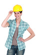Female builder touching hat