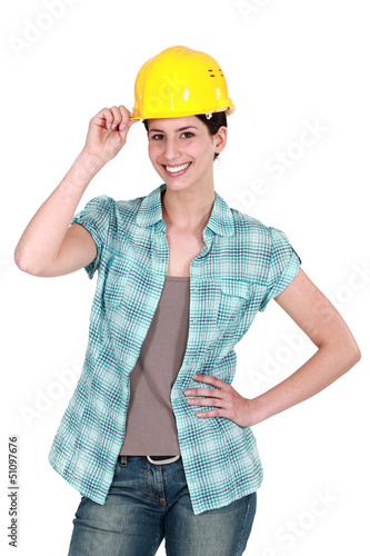 Photo: Female builder touching hat Female builder touching hat