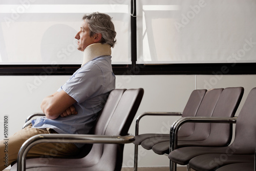 Photo: Man With Neck Injury Waiting In Lobby Man With Neck Injury Waiting In Lobby