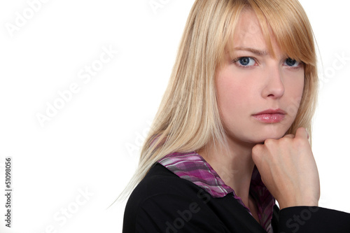Photo: portrait of a thoughtful woman putting her chin on the fist portrait of a thoughtful woman putting her chin on the fist