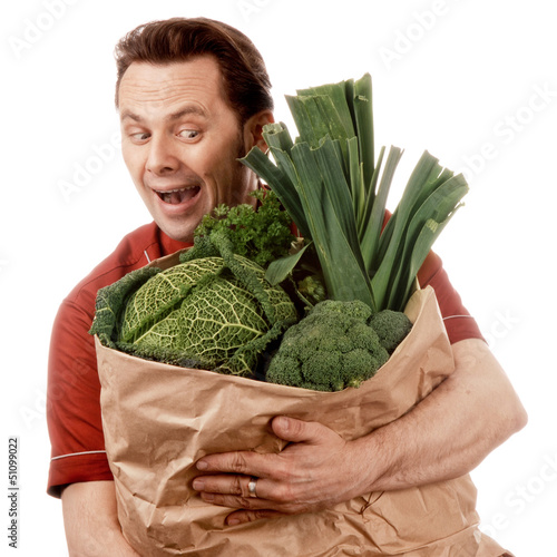 Photo: Man holding bag full of vegetables Man holding bag full of vegetables