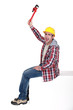 Angry tradesman holding a pipe wrench