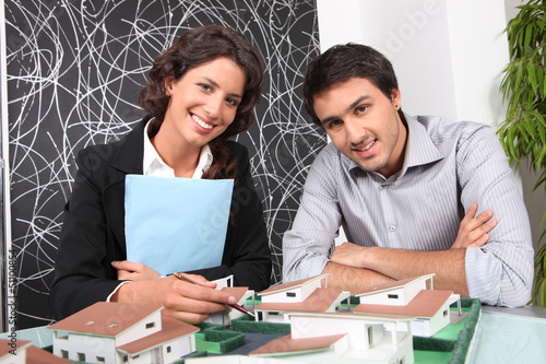 Photo: People looking at a model of a housing estate People looking at a model of a housing estate