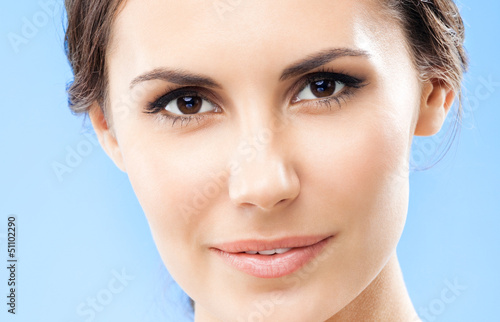 Photo: Portrait of beautiful woman, on blue Portrait of beautiful woman, on blue