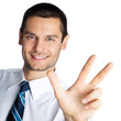 Businessman showing three fingers, isolated