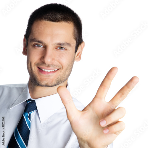 Photo: Businessman showing three fingers, isolated Businessman showing three fingers, isolated
