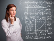 Beautiful school girl thinking about complex mathematical signs
