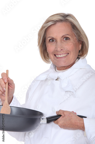 Photo: senior chef holding a pan senior chef holding a pan
