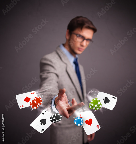 Photo: Young man playing with poker cards and chips Young man playing with poker cards and chips