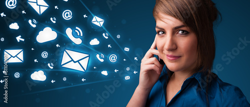 Photo: Young lady making phone call with message icons Young lady making phone call with message icons