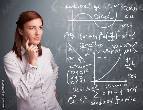 Photo: Beautiful school girl thinking about complex mathematical signs Beautiful school girl thinking about complex mathematical signs